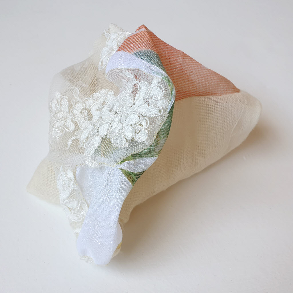 Amorphous fabric construction made from lace and other textiles.