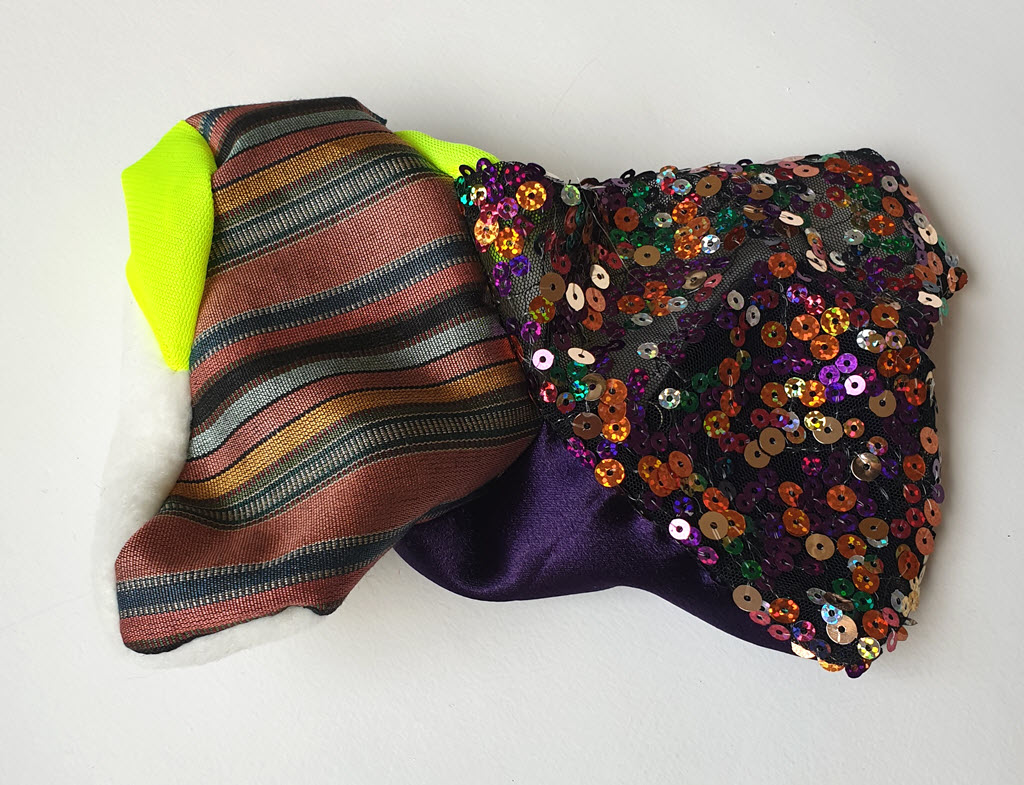 Amorphous fabric construction made from neon fabric and other textiles.