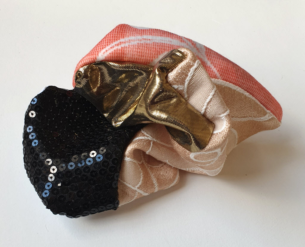 Amorphous fabric construction made from sequined fabric and other textiles.