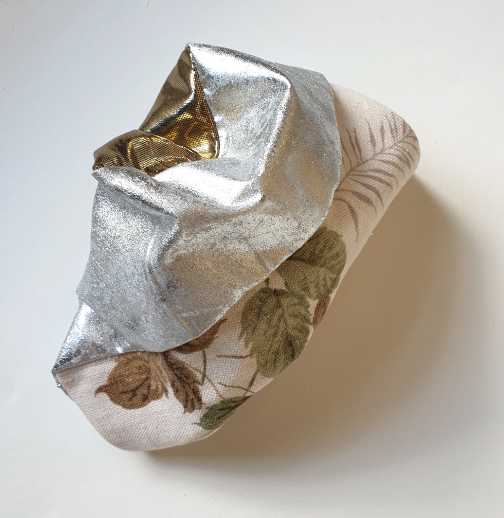 Amorphous fabric construction made from silver fabric and other textiles.