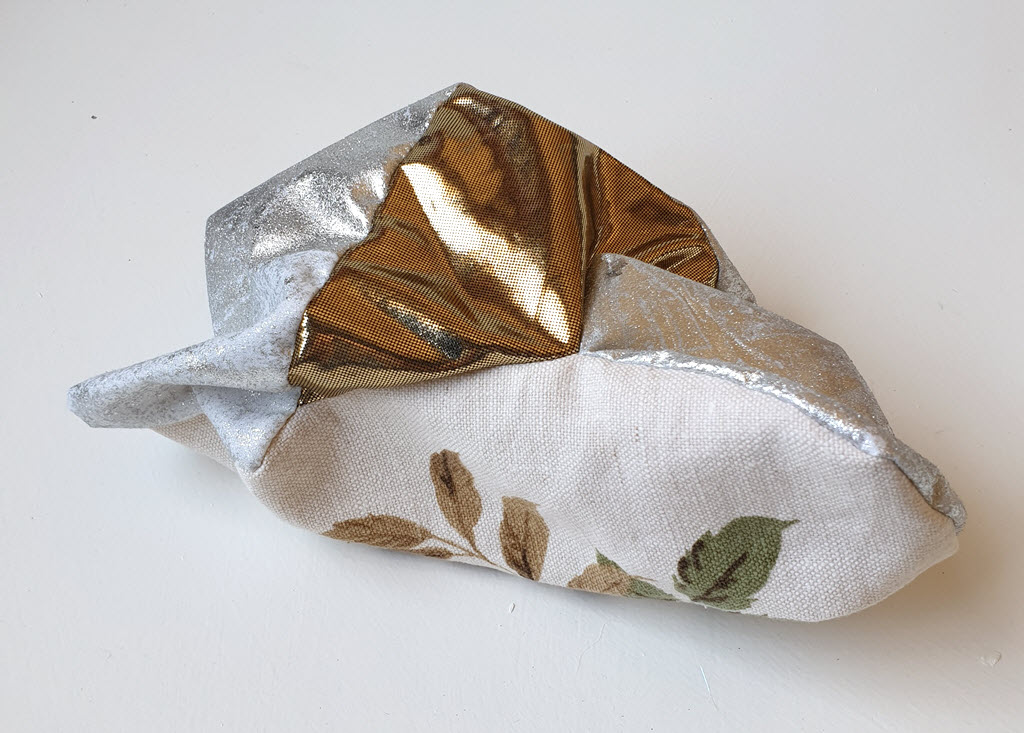 Amorphous fabric construction made from silver fabric and other textiles.